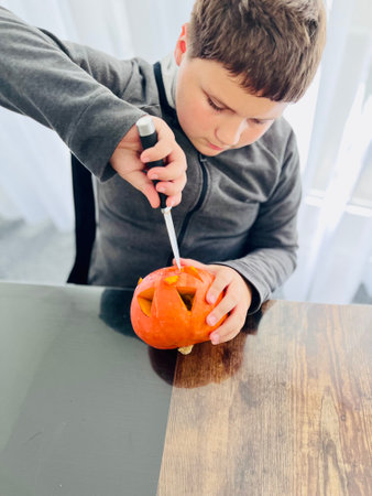 Child carving pumpkin for Halloween. High quality photoの写真素材