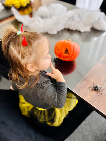 little girl in halloween costume eat sweet tricks with jack pumpkin. High quality photoの写真素材