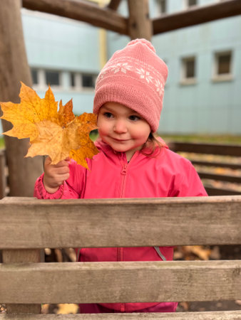 Autumn season leisure. Atmosphere of autumn. Adorable smiling schoolgirl autumn foliage background. Good mood. Happy child. Welcome october.の写真素材