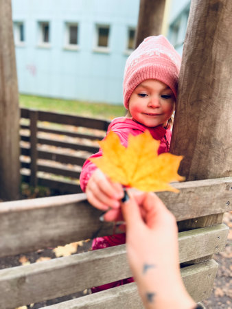 Autumn season leisure. Atmosphere of autumn. Adorable smiling schoolgirl autumn foliage background. Good mood. Happy child. Welcome october.の写真素材