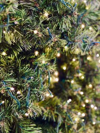 Big christmas decorated pine tree close up, white lights. Christmas decorations are lights and baubles. Happy new year, christmas celebration lights.の写真素材