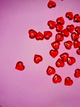 Pink background with glitter hearts for Valentine's Day. Beautiful wrapping paper or background for...