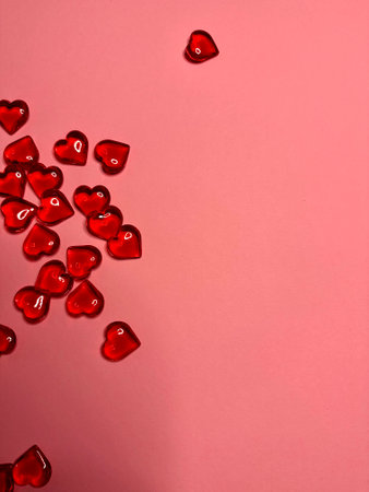 Pink background with glitter hearts for Valentine's Day. Beautiful wrapping paper or background for a postcard. Place for text, banner for websiteの写真素材