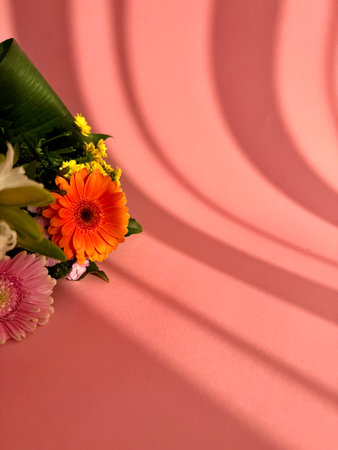 a bouquet of various summer wild flowers on a delicate pink background in the form of a frame with a place for text. High quality photoの写真素材