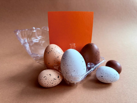 Notebook with Easter Eggs. Spiral notepad on spring beige background. Top view of open writing pad...