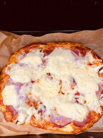 Slice of hot pizza large cheese lunch or dinner crust seafood meat topping sauce.の写真素材
