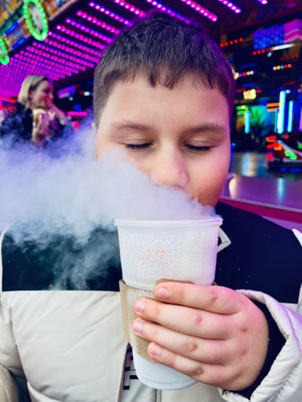 Smoke effect coming out from plastic water bottle in hand on birthday party blurred background....