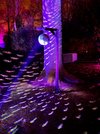 Disco ball with bright rays, night party background photo. High quality photo