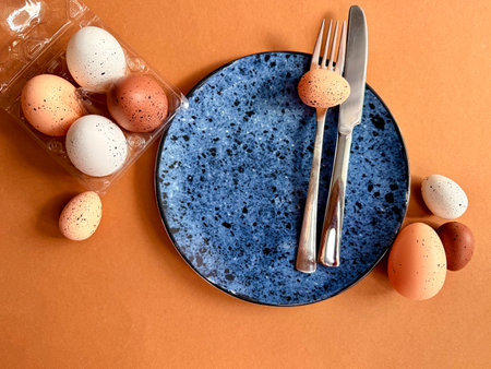 Easter still life. Festive table place setting decoration with colored eggs.の写真素材