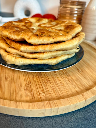 Romanian and Moldovan pies are fried in a large frying pan. Traditional homemade round pies - Placinta. Bakery products. Rustic style. Street Food Fair. Chisinau. Moldova.の写真素材