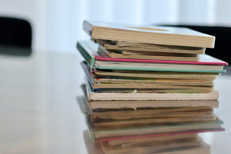 A collection of colorful books stacked neatly on a wooden table, evoking a sense of warmth and inviting readers to explore the stories within them.