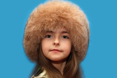 Girl in a fluffy cap from natural fur.の写真素材