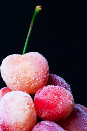 Frozen sweet cherry on black background.の写真素材