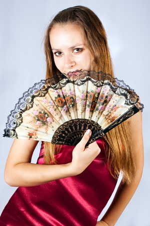 Portrait of the beautiful girl with a fan.の写真素材