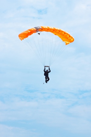 parachutist in the blue sky on a parachuteの写真素材