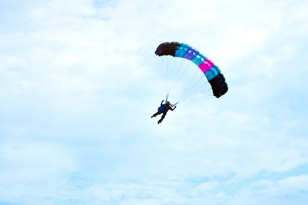 parachutist in the blue sky on a parachuteの写真素材