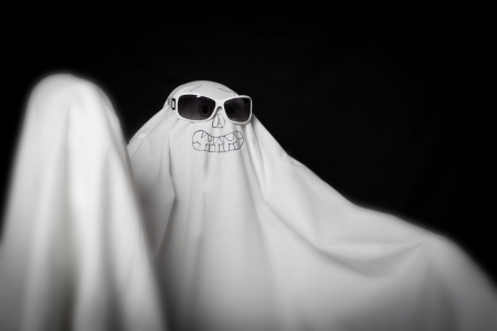 Halloween a ghost in sunglasses in the darkの写真素材