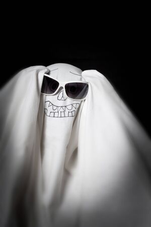 Halloween a ghost in sunglasses in the darkの写真素材