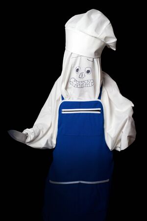 Halloween. cook a ghost with a knife in the darkの写真素材