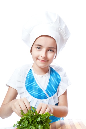 Happy little chef cook with parsley on a white backgroundの写真素材