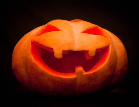 Halloween pumpkin lantern candle in the darkの写真素材