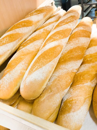 Bread baguettes in a basket in the baking shopの写真素材