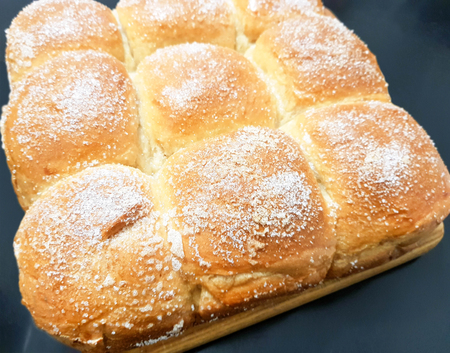 Appetizing ruddy buns with sesame seeds on a baking sheet, homemade pastries. Freshly baked wheat buns with sesame seeds.の写真素材