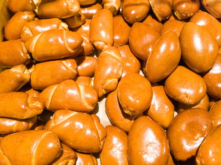 many fresh ruddy little buns and croissants on the shelf in the bakery. food background.の写真素材