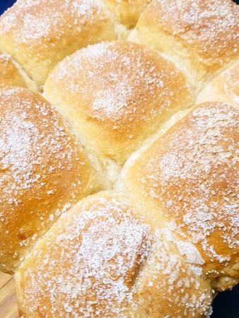 Appetizing ruddy buns with sesame seeds on a baking sheet, homemade pastries. Freshly baked wheat buns with sesame seeds.の写真素材