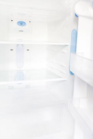 Interior of an empty open white refrigeratorの写真素材