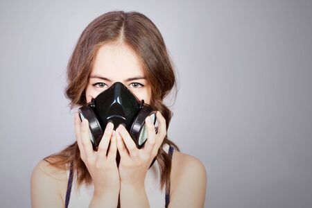 Coronavirus (COVID-19) and healthcare concept. Girl teenager in a respirator in panic, respiratory protection.の写真素材