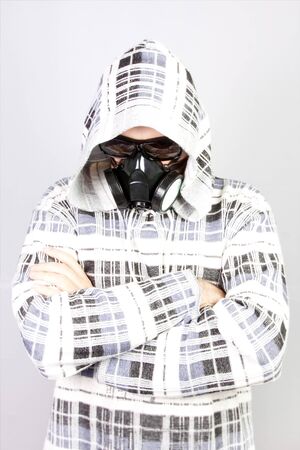 Coronavirus (COVID-19) and healthcare concept. Respiratory protection. Portrait of young man in black with respirator on his face over gray backgroundの写真素材