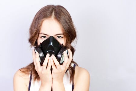 Coronavirus (COVID-19) and healthcare concept. Girl teenager in a respirator in panic, respiratory protection.の写真素材