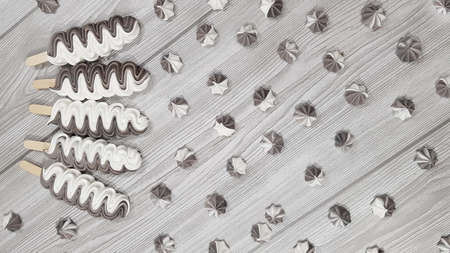 Colorful meringue lollipop on a gray background.の写真素材