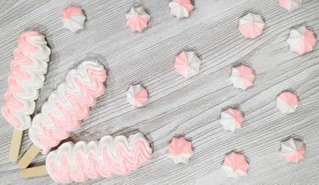 Colorful meringue lollipop on a gray background.の写真素材