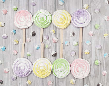 Colorful meringue lollipop on a gray background.の写真素材
