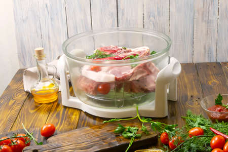 Fresh meat in a grill on a wooden table. Selective focus, place for text.の写真素材