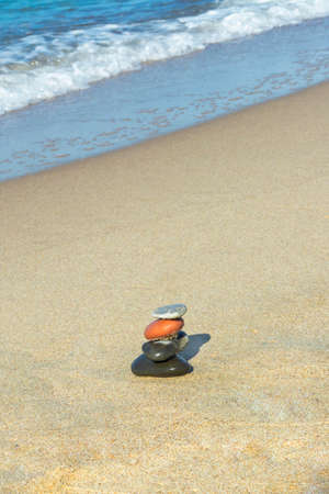 Stones in the pyramid are balanced on seashore. Harmony and meditation concept. Copy space,...