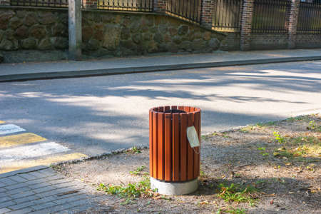 Medical mask hangs on trash can on city street. Pandemic end concept. Selective focus, fog view.の写真素材