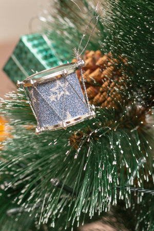Branch of Christmas tree in the snow with New Year's toy drum. Selective focus, blurred background.の写真素材