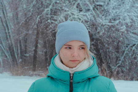 Girl teenager 15 years old on walk in winter woods holding mug of hot tea. Picnic in frosty snow.の写真素材