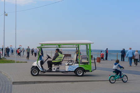 Zelenogradsk, Kaliningrad region, Russia - September 2020: Promenade along coast. Car for excursions along Baltic sea. Golf car for transporting tourists.のeditorial素材