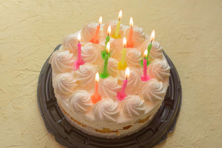 Cake with lit candles for birthday of eleven years. Selective focus, fog view.の写真素材