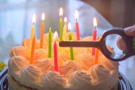Candles are lit on birthday cake. Close-up, blur, fog.
