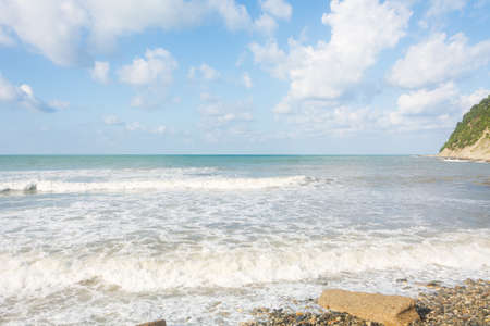 Surf with waves on the shore. beautiful summer sky.