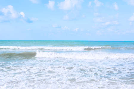 Sea waves with white foam. Surf on the beach. Tinted in blue.