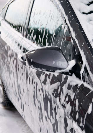 Gray car washes in soap from a detergentの写真素材