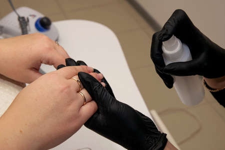 close-up of nail disinfection with cosmetic product