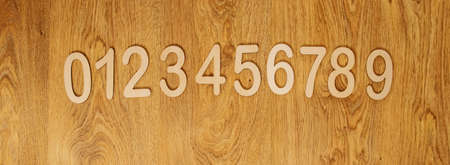 Flatley, top view on wooden numbers from zero to nine lying in order on wooden background with copy...
