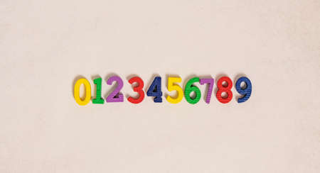 Top view of multicolored small bright childish numbers for development from zero to nine lying on a...